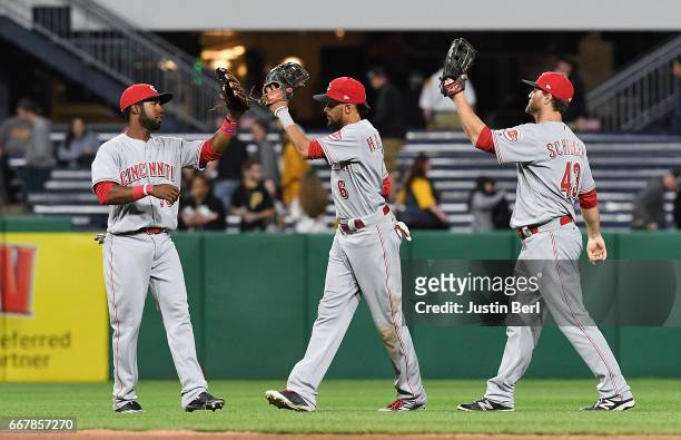Arismendy Alcantara of the Cincinnati Reds celebrates with Billy Hamilton and Scott Schebler after the final out in an 9-2 win over the Pittsburgh...