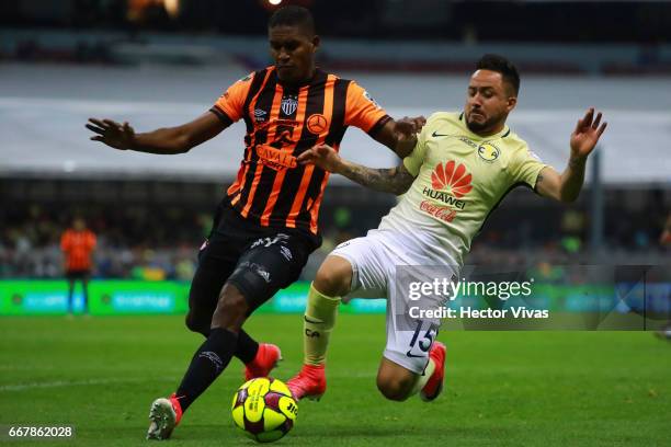 Osmar Mares of America struggles for the ball with Brayan Beckeles of Necaxa during the 10th round match between America and Necaxa as part of the...