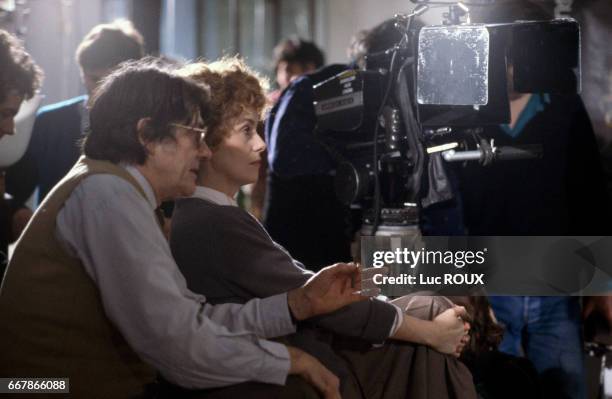 French actress Catherine Deneuve and French director Jean-Pierre Mocky on the set of his film Agent Trouble .