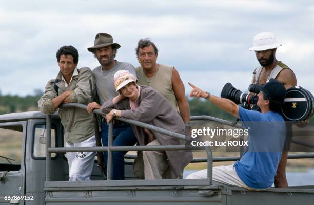 French actors Richard Anconina, Jean-Paul Belmondo and Marie-Sophie L. And director Claude Lelouch on the set of Lelouch's film Itineraire d'un...