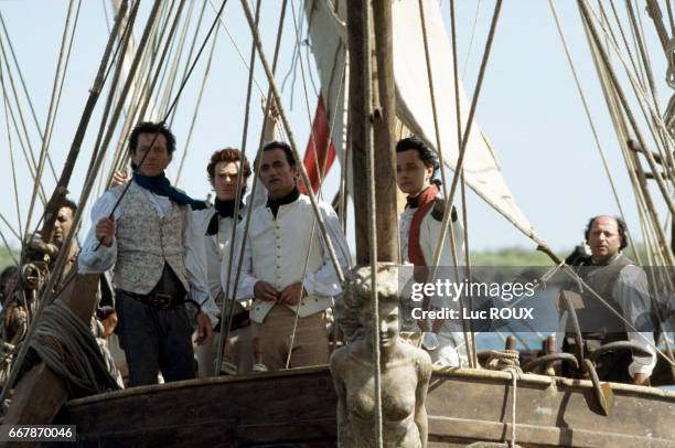 French actor and director Bernard Giraudeau, and actors Thierry Fremont, Richard Bohringer, Vincent de Bouard, and Roland Blanche on the set of...