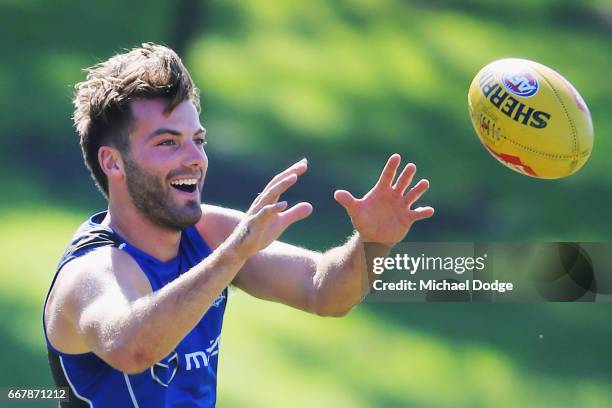 Luke McDonald of the Kangaroos marks the ball during a North Melbourne Kangaroos AFL training session at Arden Street Ground on April 13, 2017 in...