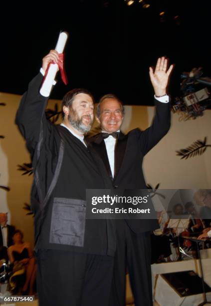 Pavel Lungin receives the Best Director Award from actor Ben Gazzara for the film Taksi-Blyuz, or Taxi Blues, at the Cannes Film Festival closing...