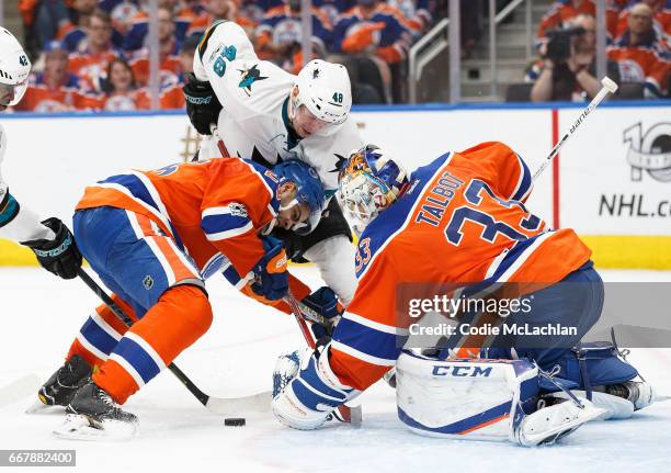 Darnell Nurse and goalie Cam Talbot of the Edmonton Oilers defend the net against Tomas Hertl of the San Jose Sharks in Game One of the Western...