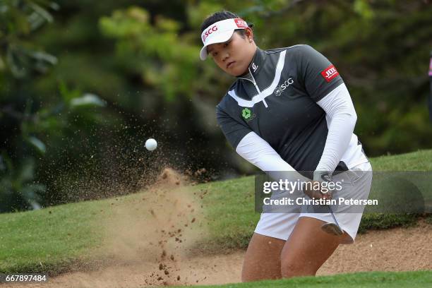 Ariya Jutanugarn of Thailand chips from the bunker onto the eighth green during the first round of the LPGA LOTTE Championship Presented By Hershey...