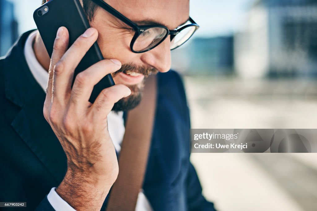 Young businessman talking on phone