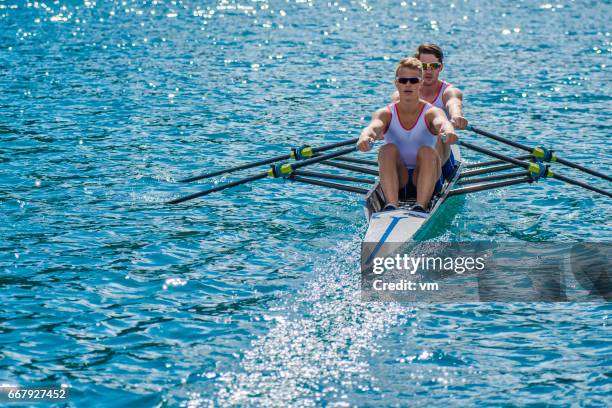 two rowers on a lake - crew rowing stock pictures, royalty-free photos & images