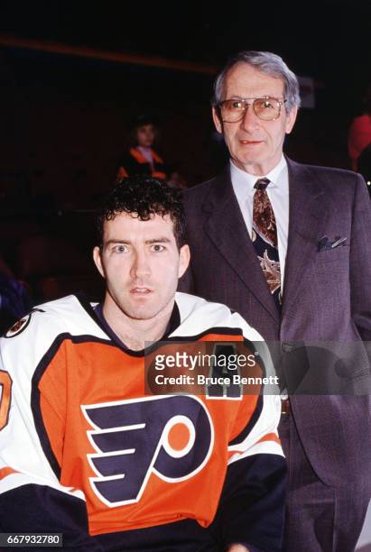 Kevin Dineen of the Philadelphia Flyers poses with his father and former NHL player Bill Dineen circa March, 1992 in Philadelphia, Pennsylvania.