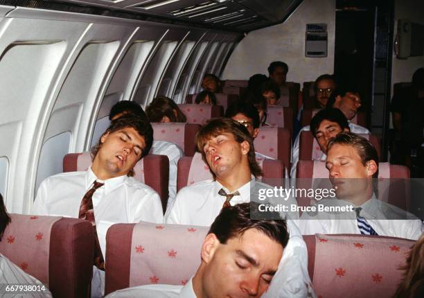 Kevin Hatcher, Mike Modano and Jeremy Roenick of Team USA sleep on the plane as they travel during the 1991 Canada Cup circa August, 1991.