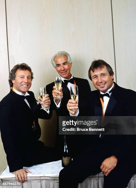 Former NHL goalie Tony Esposito, owner of the Philadelphia Flyers Ed Snider and former defenseman Brad Park have a toast during the 1988 NHL awards...