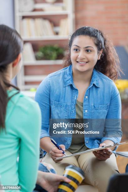 attentive therapist listens to patient - student advisor stock pictures, royalty-free photos & images