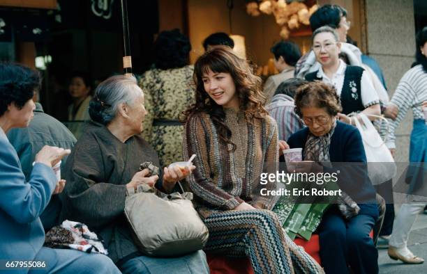 Actress Sophie Marceau chats with a local woman while touring Tokyo. Marceau is in Japan to promote a new perfume, Champs Elysses, for the French...