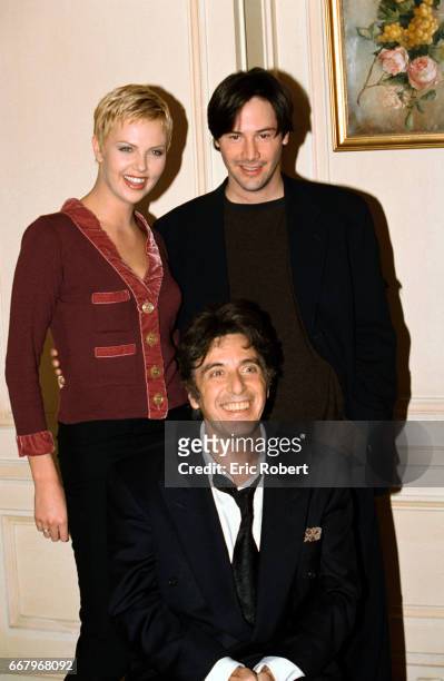 Actors Charlize Theron, Al Pacino, and Keanu Reeves attend a photocall for their film The Devil's Advocate. The film was directed by Taylor Hackford.