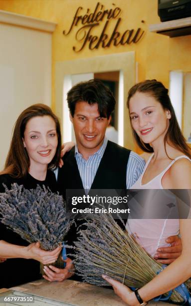 Chilean model Alejandra di Andia and model Maria Ines Ribero hold boquets of lavender while standing with celebrity hairstylist Frederic Fekkai in...