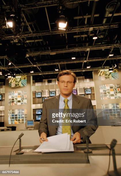 Laurent Delahousse broadcasts a news report from the studio of French television station LCI. Delahousse is the anchor for LCI, a 24 hour cable news...