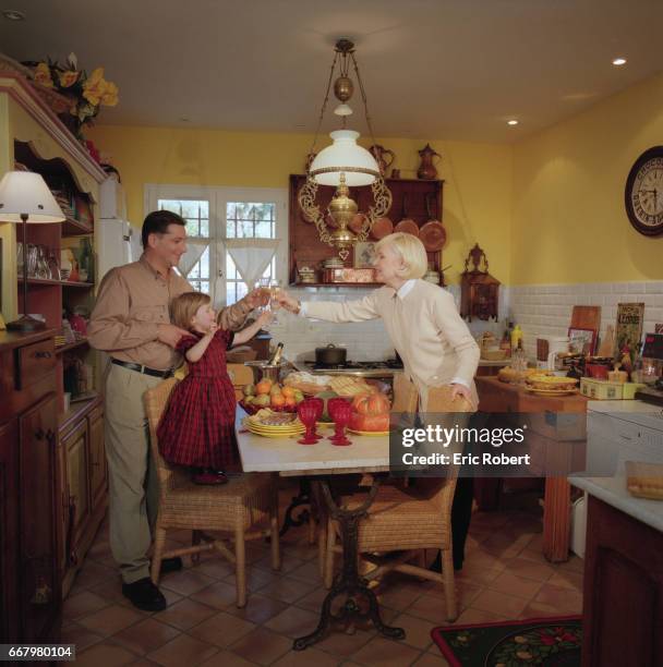 French singer Michele Torr, her husband Jean-Pierre Murzilli, and their daughter Charlotte celebrate the holidays with a family toast. The kitchen...