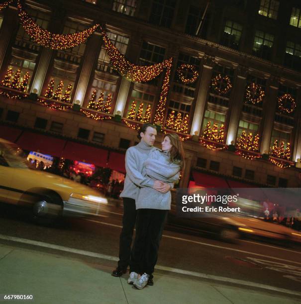 Muriel Amori, an American writer who is popular in France, and her husband Gareth Evans hugging along a busy Manhattan street during the Christmas...