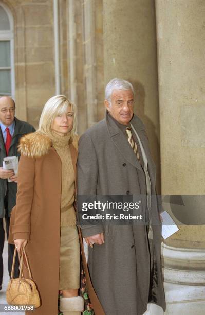 French actor Jean-Paul Belmondo and his girlfriend Natty arrive at the Palais de l'Elysee. French President Jacques Chirac presented the Legion of...