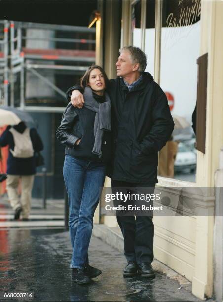 Gerard Lenorman and his daughter Clemence pose in front of a restaurant.