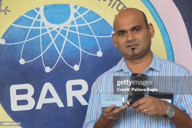 Scientist Vineet Sinha poses with a credit card sized life-saving electro cardio graphic machine at the Bhabha Atomic Research Centre on March 4,...