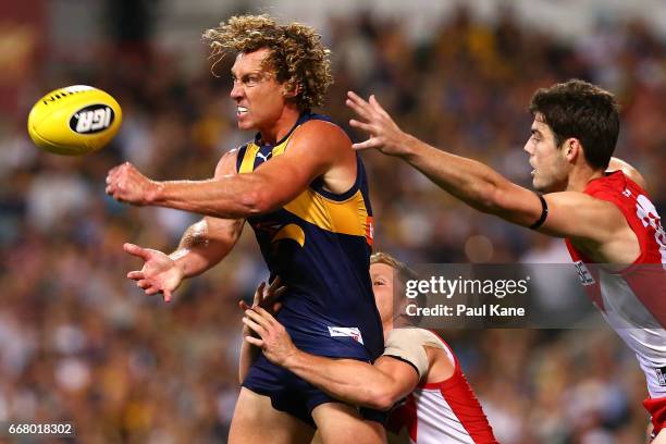 Matt Priddis of the Eagles gets his handball away while being tackled by Daniel Hannebery of the Swans during the round four AFL match between the...