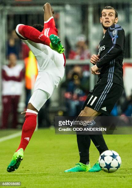 Real Madrid's Welsh forward Gareth Bale and Bayern Munich's Austrian defender David Alaba vie for the ball during the first-leg quarter final...