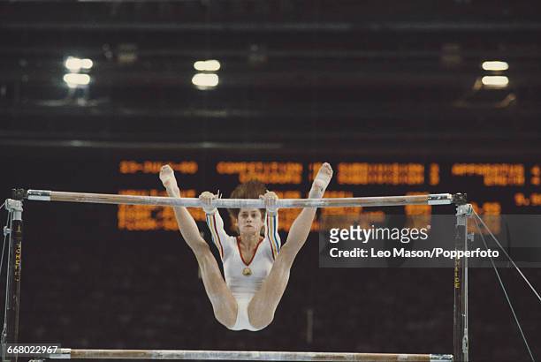 Romanian gymnast Nadia Comaneci pictured in action during competition on the uneven bars, part of the women's artistic team all-around competition at...