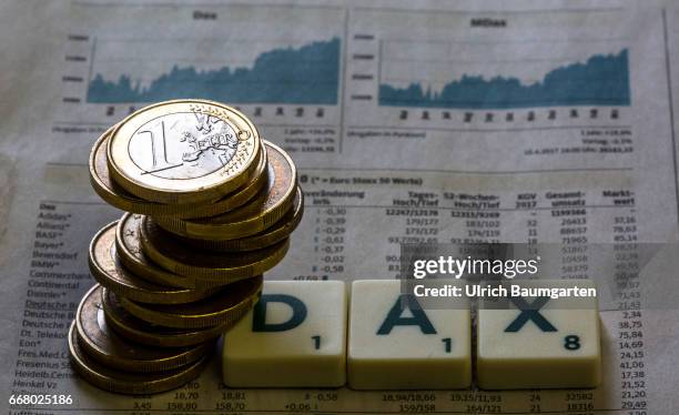 Symbol photo on the topics German stock index, DAX, stock exchange, economy, world economy, etc. The photo shows a stack of euro coins on a DAX rate...