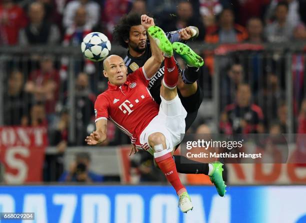 Arjen Robben of FC Bayern Muenchen and Marcelo of Real Madrid compete for the ball during the UEFA Champions League Quarter Final first leg match...