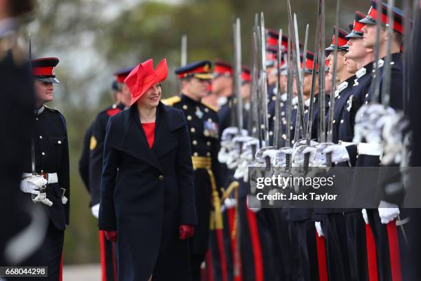 British Prime Minister Theresa May inspects the Officer Cadets during the Sovereign's Parade at Royal Military Academy Sandhurst on April 13, 2017 in...