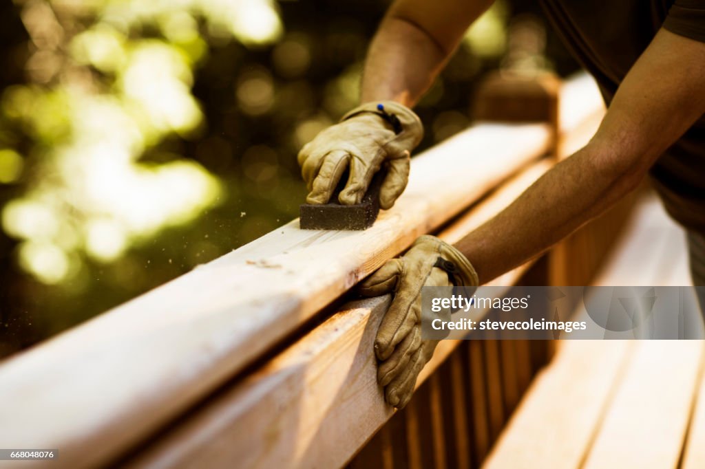 Carpenter Sanding Cedar Deck