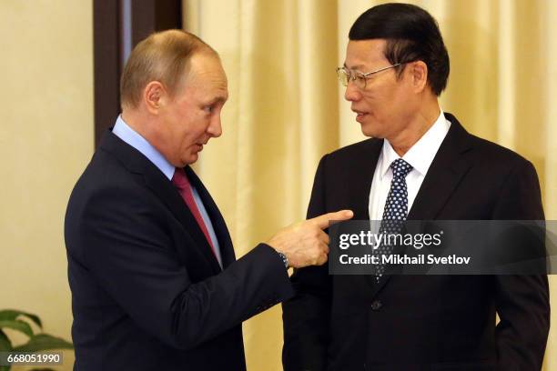 Russian President Vladimir Putin greets Chinese Vice Primier Zhang Gaoli during their meeting at the Novo-Ogaryovo State Residence on April 2017...