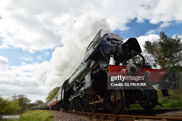 The Flying Scotsman steam locomotive makes its way from Sheffield Park station to East Grinstead on the Bluebell Railway Line in East Sussex,...