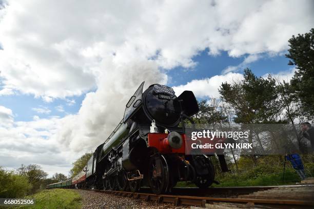 The Flying Scotsman steam locomotive makes its way from Sheffield Park station to East Grinstead on the Bluebell Railway Line in East Sussex,...