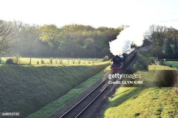 The Flying Scotsman steam locomotive makes its way from Sheffield Park station to East Grinstead on the Bluebell Railway Line in East Sussex,...