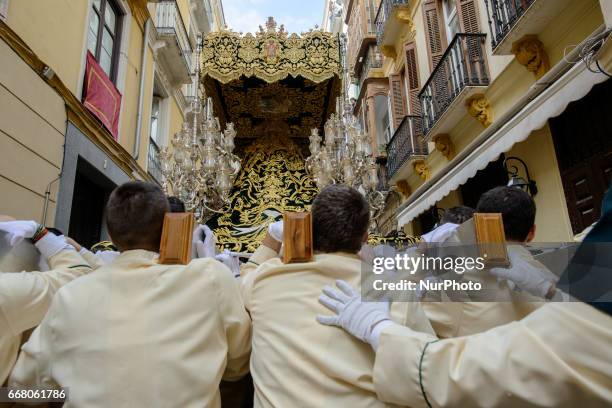 Devotees take part in the 'Domingo de Ramos' procession on April 9, 2017 in Malaga, Spain, during the Holy Week. Seven procesiones came out from...