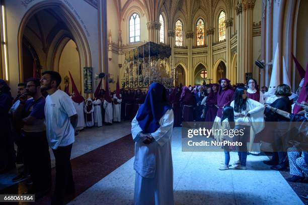 Devotees take part in the 'Domingo de Ramos' procession on April 9, 2017 in Malaga, Spain, during the Holy Week. Seven procesiones came out from...