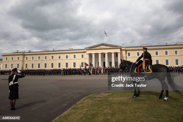 Officer Cadets take part in the Sovereign's Parade at Royal Military Academy Sandhurst on April 13, 2017 in Camberley, England. British Prime...