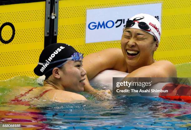 Winner Reona Aoki is congratulated by second place Satoi Suzuki after competing in the Women's 100m Breaststroke final during day one of the Japan...