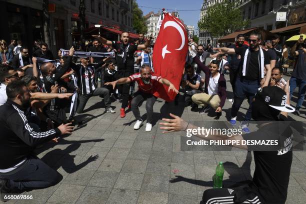 Besiktas' fans wave Turkey's national flag as they gather in the streets of Lyon, hours before the Europa League football match Lyon vs Besiktas on...