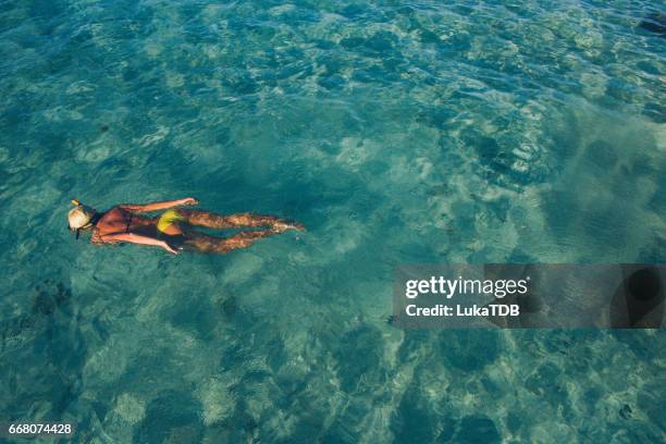 blonde girl snorkeling on maldives - thunderstorm ocean blue stock pictures, royalty-free photos & images