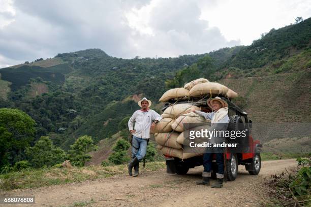 men transporting sacks of coffee in a car - south america stock pictures, royalty-free photos & images