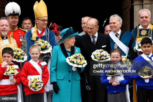 Britain's Queen Elizabeth II and Britaqin's Prince Philip, Duke of Edinburgh pose with Yeoman of the Guard following the Royal Maundy service at...