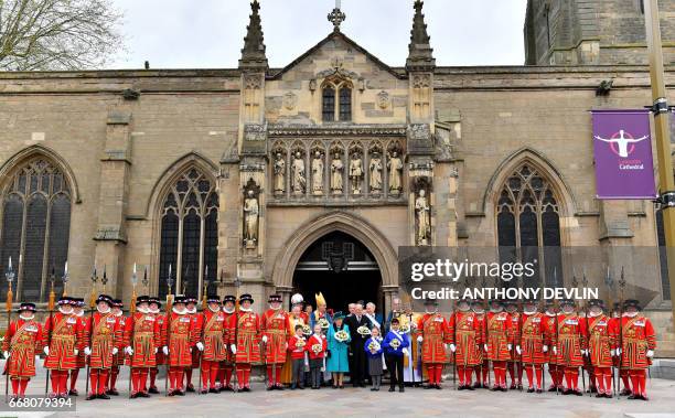 Britain's Queen Elizabeth II and Britain's Prince Philip, Duke of Edinburgh pose with Yeoman of the Guard following the Royal Maundy service at...