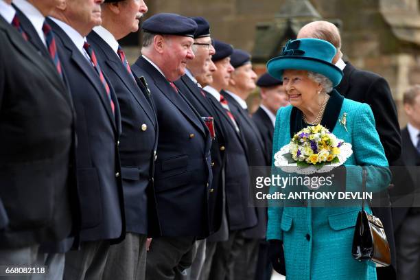 Britain's Queen Elizabeth II and Britain's Prince Philip, Duke of Edinburgh meet former servicemen following the Royal Maundy service at Leicester...
