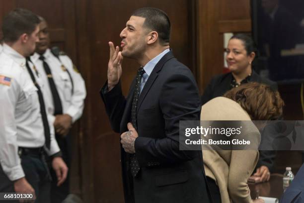 Former New England Patriots tight end Aaron Hernandez blows a kiss to his fiancées Shayanna Jenkins from the defense table during jury deliberations...