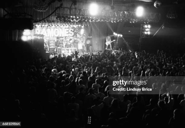 View of the full stage from the balcony of The Ramones with Johnny Ramone and CJ Ramone standing on crates toward back of stage, Marky Ramone on...