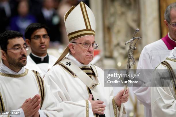 Pope Francis leaves at the end of the Chrism Mass for Holy Thursday which marks the start of Easter celebrations in St. Peter's Basilica in Vatican...