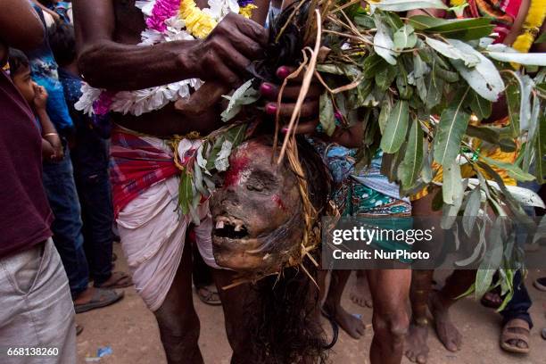 Devotee is holding a human head in his hand in Burdwan, India on 13 April 2017. &quot;Gajan&quot; is one of the prominent folk festivals of Bengal,...