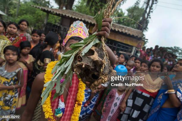 Devotee is holding a human head in his hand in Burdwan, India on 13 April 2017. &quot;Gajan&quot; is one of the prominent folk festivals of Bengal,...